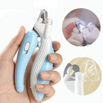 A handheld nail clipper tool with a light blue and white ergonomic handle is shown being held by a person's hand. Two circular inset images on the right show close-up views of the clipper in use and a clear protective cover.